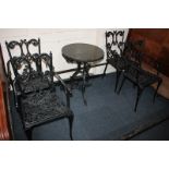 A set of four black painted metal garden chairs, with scroll backs and seats, together with a garden