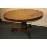 A Victorian rosewood circular dining table with tilt top, on foliate carved pedestal art triform