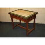 An unusual cream and green tile top rectangular table, possibly a shop/food preparation counter,