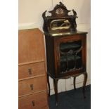 An Art Nouveau glazed cabinet, raised back with mirror shelf, all pierced, surmount above glazed