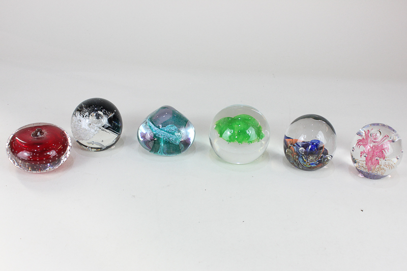 A collection of six glass paperweights, to include a Caithness jellyfish limited edition 232/500