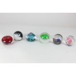 A collection of six glass paperweights, to include a Caithness jellyfish limited edition 232/500