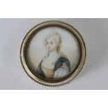 A 19th century ivory circular trinket pot with painted miniature lid depicting a woman, signed T.