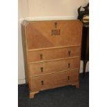 A Warring and Gillows Art Deco limed oak cabinet, fall front with carved floral panel, above three