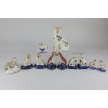 A collection of Staffordshire pottery animals comprising two pairs of cats, a pair of greyhounds,