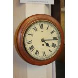 A circular wooden framed wall clock, with Roman numerals (a/f), 28cm