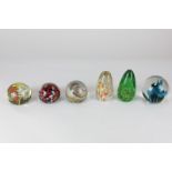 A collection of six glass paperweights, with swirling polychrome decoration, to include a Wedgwood