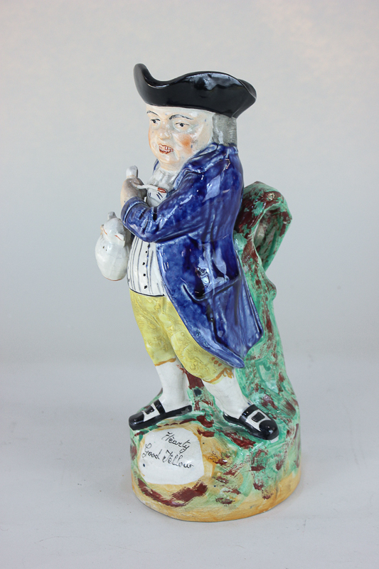 A Staffordshire pottery Toby jug, with figure holding a pitcher and a pipe, inscribed 'Hearty Good