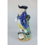 A Staffordshire pottery Toby jug, with figure holding a pitcher and a pipe, inscribed 'Hearty Good