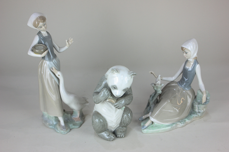 A Lladro porcelain figure of a girl seated beside a dove, 17cm, another feeding a goose, 23cm,
