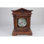 A German oak cased mantle clock, the dial with Arabic numerals, marked 'manufactured in Wurtemberg',