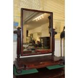 A 19th century mahogany framed dressing mirror, with fluted supports on shaped rectangular base