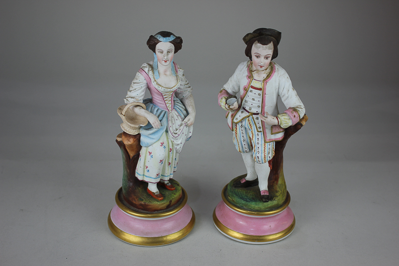 A pair of Continental bisque porcelain figures of a gentleman and a lady, in 18th century dress,