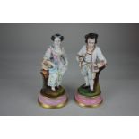 A pair of Continental bisque porcelain figures of a gentleman and a lady, in 18th century dress,
