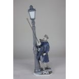 A Lladro porcelain figure of a lamp lighter, the base marked Daisa 1983, (a/f) 47cm high