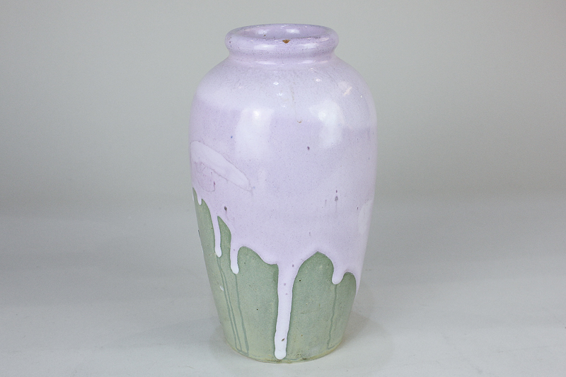 A pottery vase decorated with lilac drip glaze on green grey ground, bearing incised 'W.