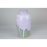 A pottery vase decorated with lilac drip glaze on green grey ground, bearing incised 'W.