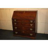 A George III oak bureau, the fall front enclosing interior of drawers with central recess flanked by