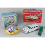 A Louis Marx battery operated remote control MI police car and an OK Space Ship DB-2, made in Hong