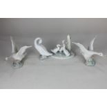 Three Lladro porcelain models of white geese in various poses one unglazed, 12cm, together with a