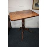 A 19th century mahogany rectangular side table with tilt top on turn baluster stem and tripod