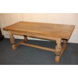 A Jacobean style oak refectory table, rectangular top, on carved baluster supports, with low