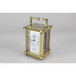 A gilt brass cased carriage clock, the dial and movement marked Lionel Peck, London, with Roman