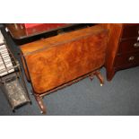 A walnut drop leaf Sutherland table, on double turned end supports, curved feet and castors, opens