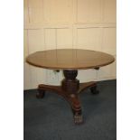 A Victorian mahogany circular table, on fluted pedestal and triform base with carved lion paw