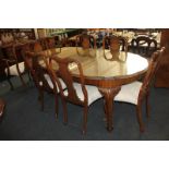 A walnut oval extending dining table, and a set of six dining chairs, with two extra leaves,
