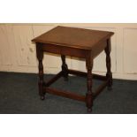 An oak rectangular side table, on block and turned supports, with low stretchers, 56cm