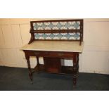 A Victorian mahogany washstand, the tile splash back with single shelf above marble top, with two