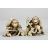 A pair of 19th century Chinese ivory netsukes depicting two seated monkeys playing with two baby