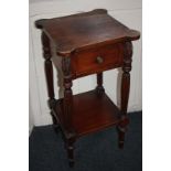 A Regency style side table, square top with rounded corners and single drawer on carved and reeded