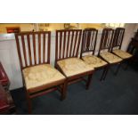 A pair of George III mahogany dining chairs, with slatted backs, drop in upholstered seats, on