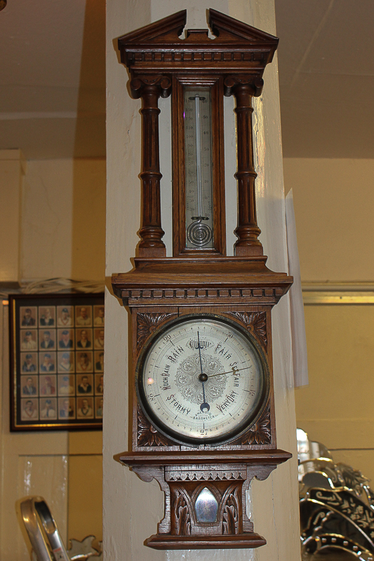 A 20th century carved oak cased aneroid barometer and thermometer, 75cm