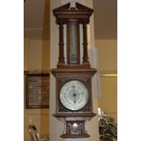 A 20th century carved oak cased aneroid barometer and thermometer, 75cm
