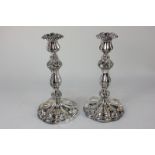 A pair of silver plated candlesticks with embossed leaf design, 25.5cm high