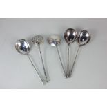 A pair of Russian 84 Zolotniks silver and niello serving spoons with foliate decorated bowl backs,