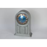 A Liberty & Co English pewter mantle clock with circular turquoise enamel dial enclosed within