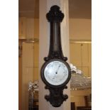 An early 20th century carved oak cased wheel barometer and thermometer, marked Short & Mason Ltd,