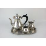 An Indian white metal three-piece tea set of teapot, cream jug and sugar bowl, baluster shape with