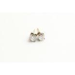 A pair of diamond single stone ear studs