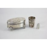A Chinese silver tot embossed with a serpent, 4cm, a George V silver oval dressing table box, 8cm,