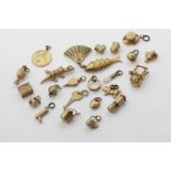 Twenty-three 9ct gold charms, and an opal charm, 46g weighable