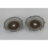 A pair of Elkington & Co silver plated wine coasters with lattice border and applied decoration of