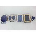 Four Elizabeth II silver photograph frames and an oval silver plated frame