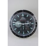 An Omega advertising wall clock, Speedmaster Professional, with three ornamental subsidiary dials,