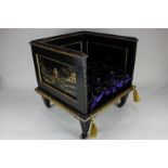 A Regency dog bed, the Japanned finish depicting figures in landscapes on black ground with gilt