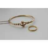 A 22ct gold wedding ring, and a gold bangle